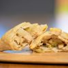 A close up of the a chigan leek and potato pasty showing the mouth-watering filling.